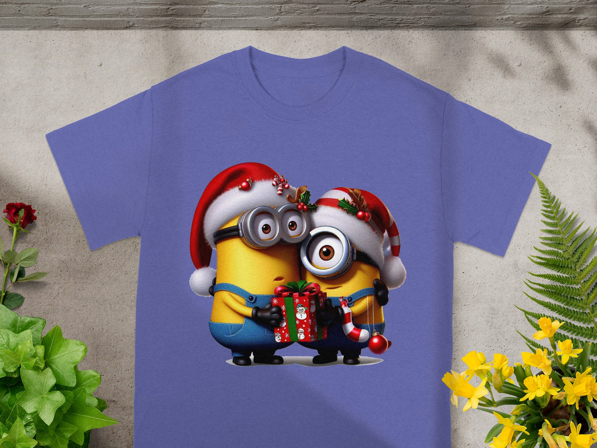Two Minions in Santa hats hold a gift and candy cane on a purple t-shirt.