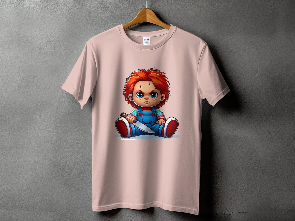 Pink t-shirt with cartoon Chucky doll holding a knife graphic.