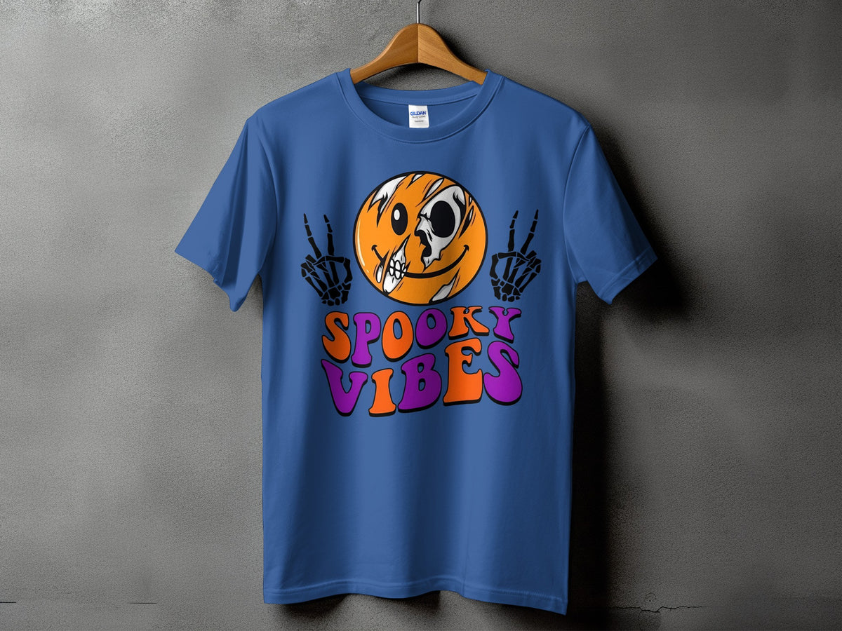 Blue t-shirt with a cracked smiley face and skeleton hands, text "SPOOKY VIBES".
