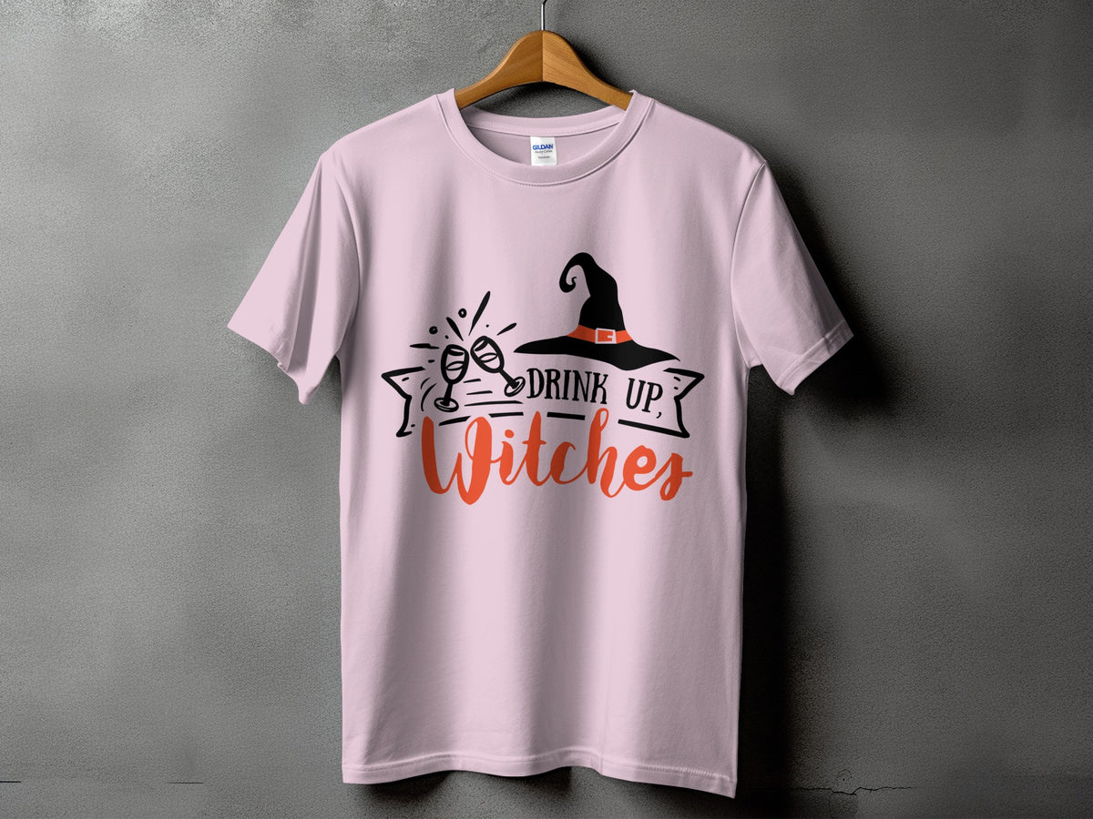 Pink t-shirt with "Drink Up, Witches" and witch hat graphic.