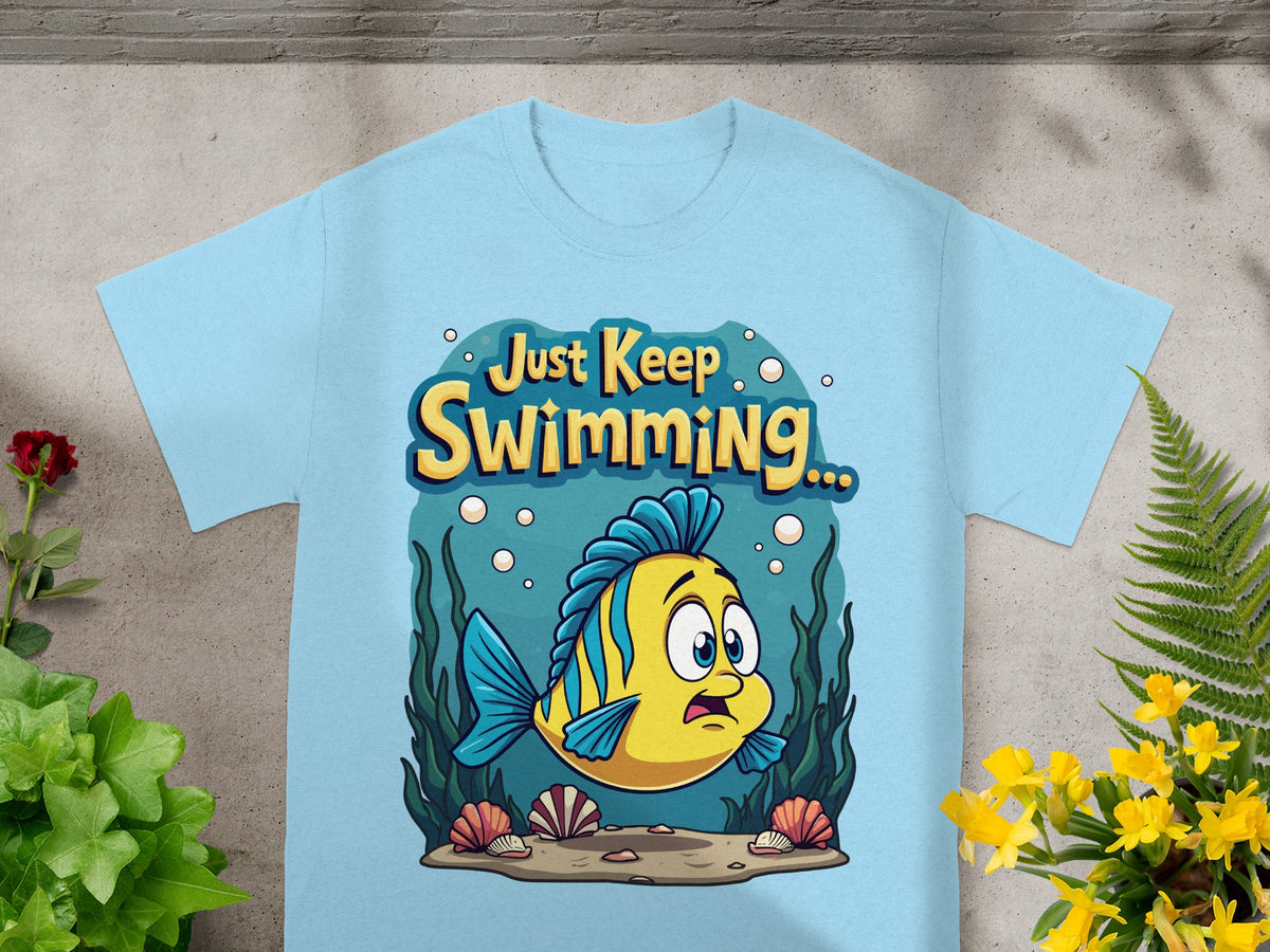 Light blue t-shirt with a cartoon yellow fish and "Just Keep Swimming..." text.