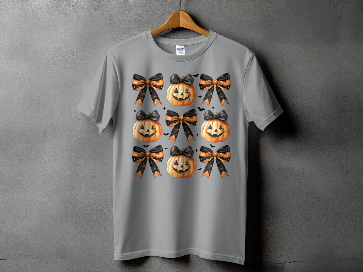 Gray t-shirt with a pattern of pumpkins and black and orange bows.