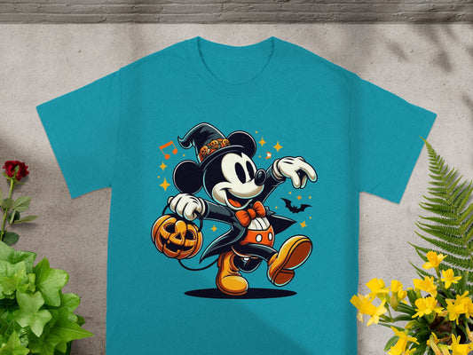 Mickey Mouse in Halloween costume holds a pumpkin while wearing a witch hat.