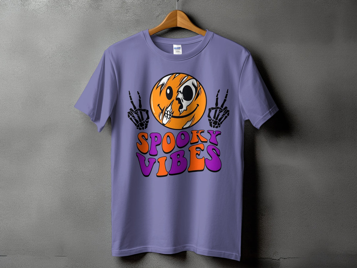 Purple t-shirt with spooky smiley face, skeleton hands, and "Spooky Vibes" text.
