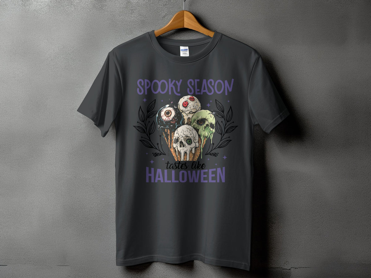Dark gray t-shirt with "Spooky Season Tastes Like Halloween" and spooky ice cream graphic.