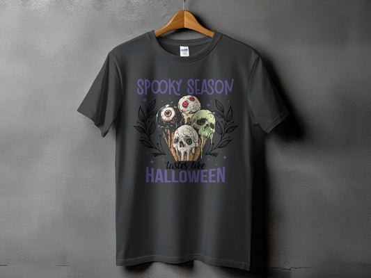 Dark gray t-shirt with "Spooky Season Tastes Like Halloween" and spooky ice cream graphic.
