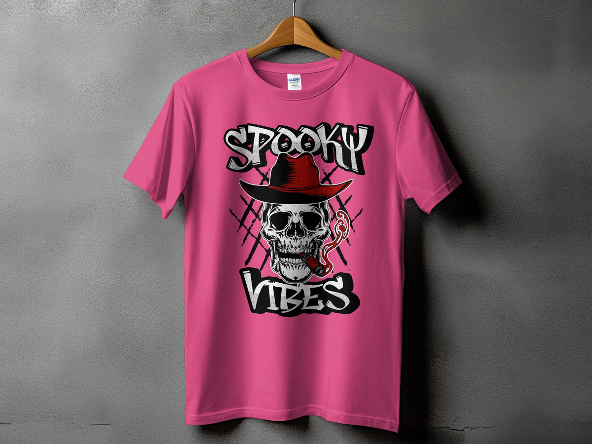 Pink t-shirt with "Spooky Vibes" graphic featuring a skull wearing a hat and smoking a cigar.