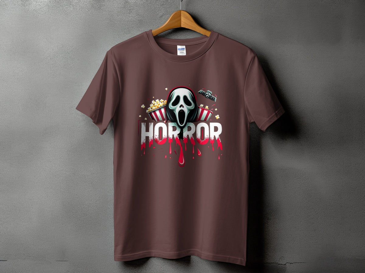 Brown t-shirt with horror mask, popcorn, movie camera, and dripping red text.