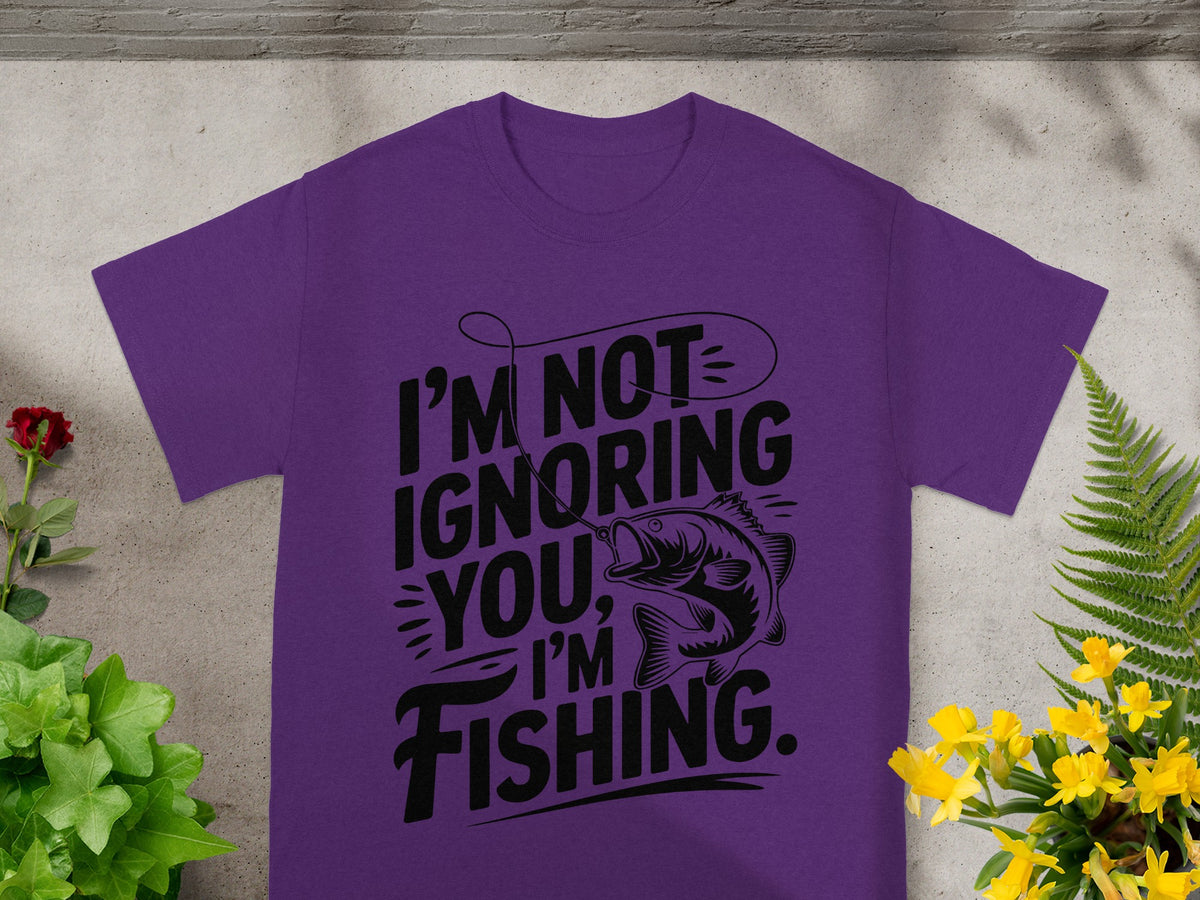 Purple t-shirt with "I'm Not Ignoring You, I'm Fishing" text and fish graphic.