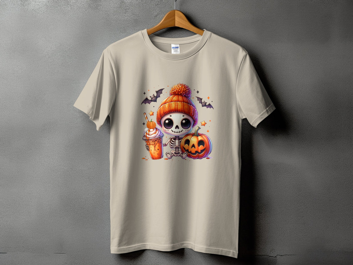 Light beige t-shirt with a cute skeleton holding a drink and pumpkin, with bats and stars.