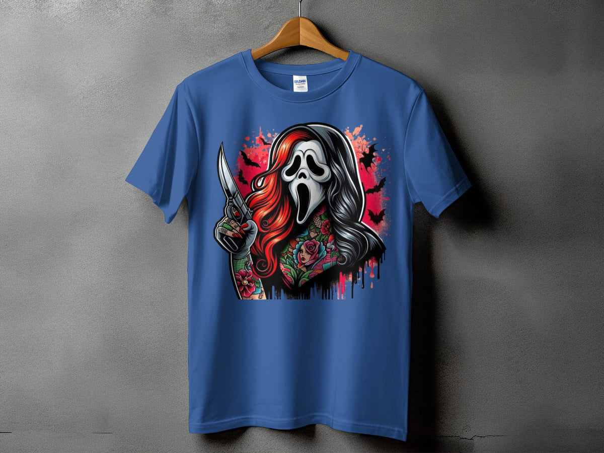 Blue t-shirt with graphic of a ghostly figure with red hair, tattoos, and a knife.