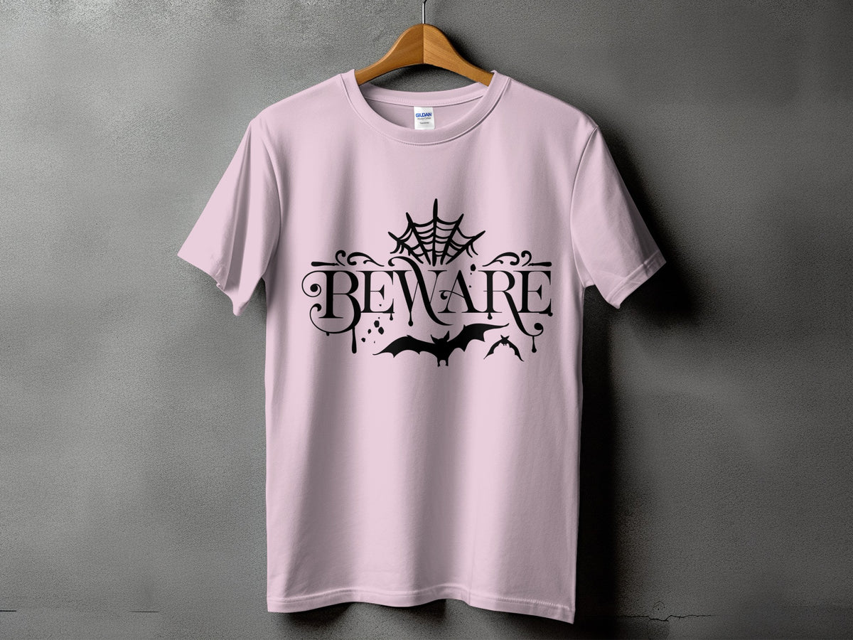 Pink t-shirt with black "BEWARE" text, cobweb, and bats design.