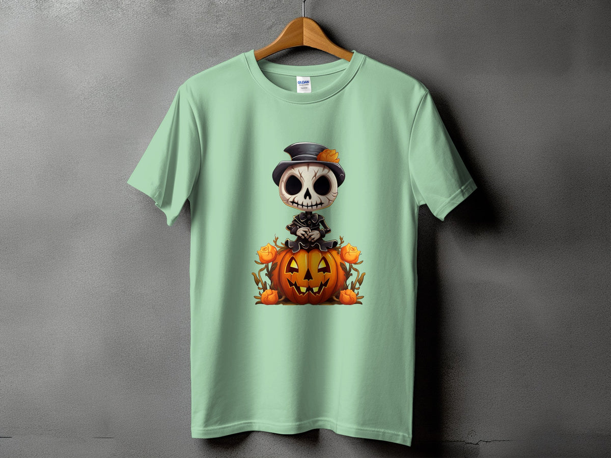 Light green t-shirt with a cartoon skeleton sitting on a jack-o'-lantern.