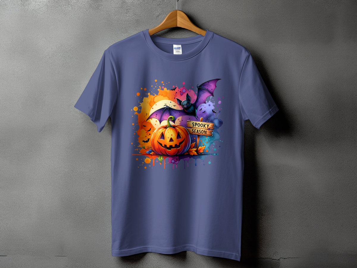 Purple t-shirt with Halloween graphic of pumpkin, bat, and "Spooky Season" sign.