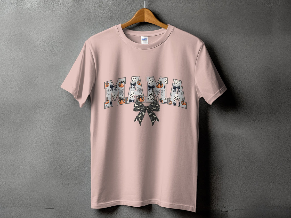 Pink t-shirt with "MAMA" text featuring Halloween motifs and a bow.