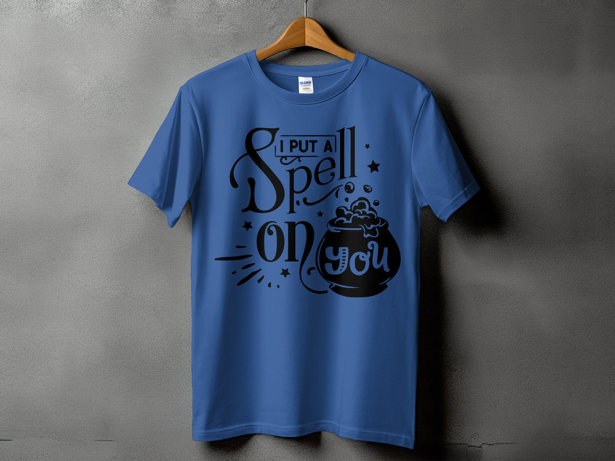 Blue t-shirt with black text reading "I PUT A Spell on you" and a cauldron graphic.