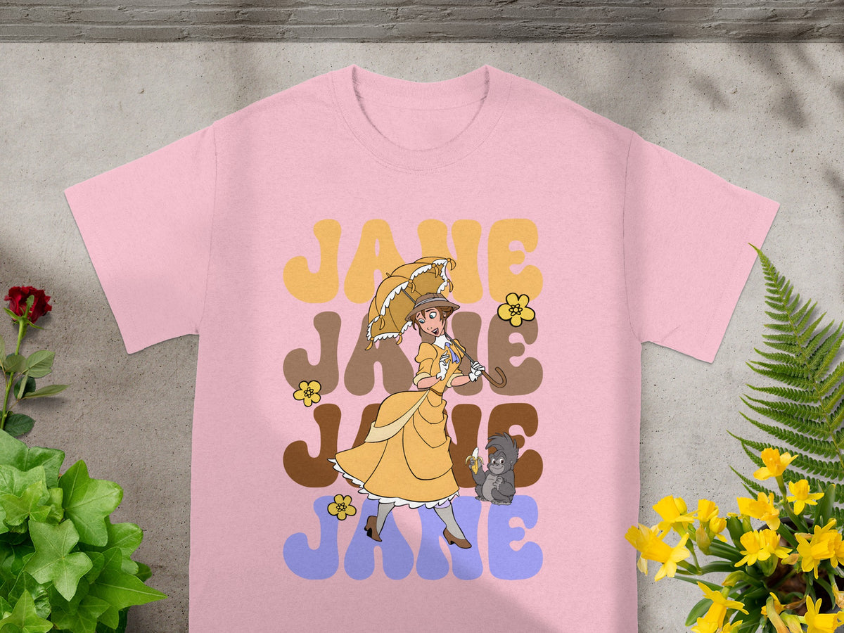 Pink t-shirt with retro "Jane" graphic featuring a woman with umbrella and monkey.
