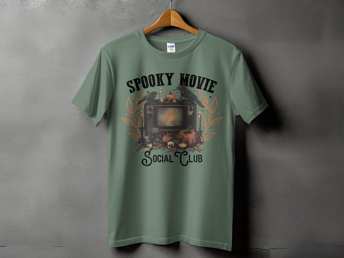 Green t-shirt with a vintage TV graphic, pumpkins, crows, and text "Spooky Movie Social Club".