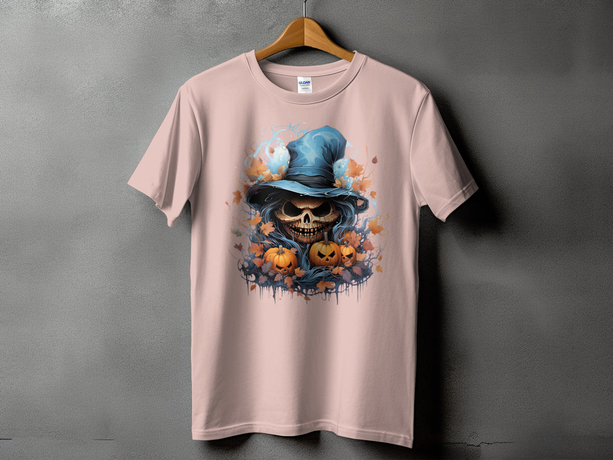 Pink t-shirt with a graphic of a skull wearing a blue hat surrounded by pumpkins and leaves.