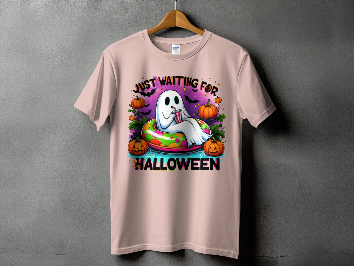 Ghost in inner tube with pumpkins and text "Just Waiting For Halloween".