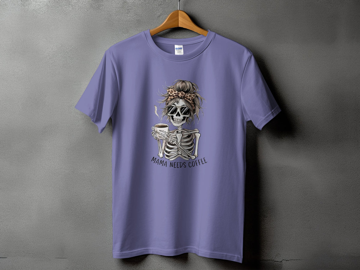 Skeleton graphic with sunglasses and coffee cup on a purple t-shirt, "Mama Needs Coffee" text.
