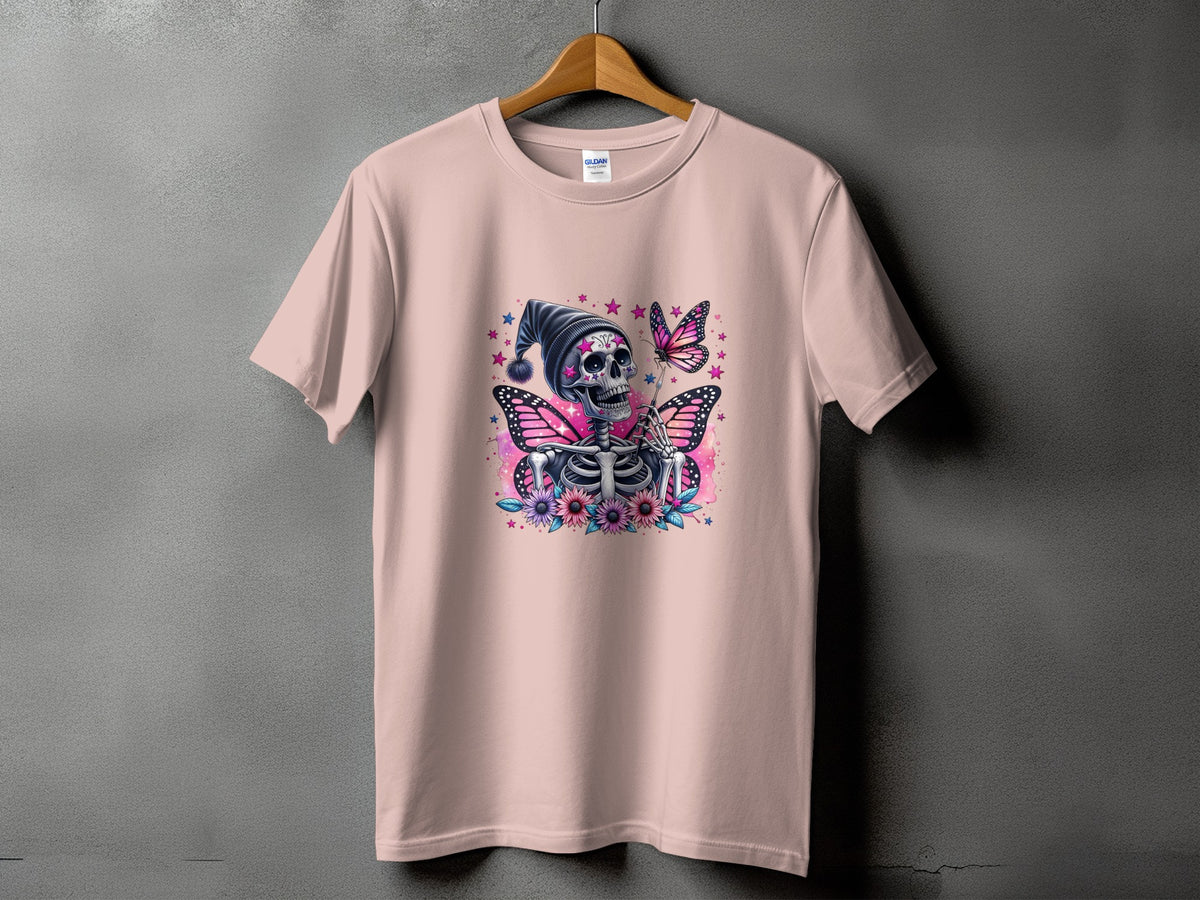 Pink t-shirt with a skeleton wearing a hat, butterflies, and flowers graphic.
