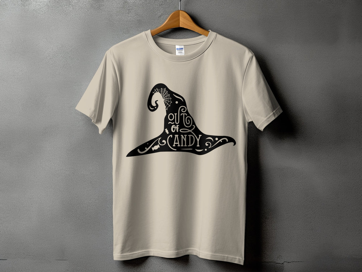 Beige t-shirt with black witch hat graphic that reads "out of candy".