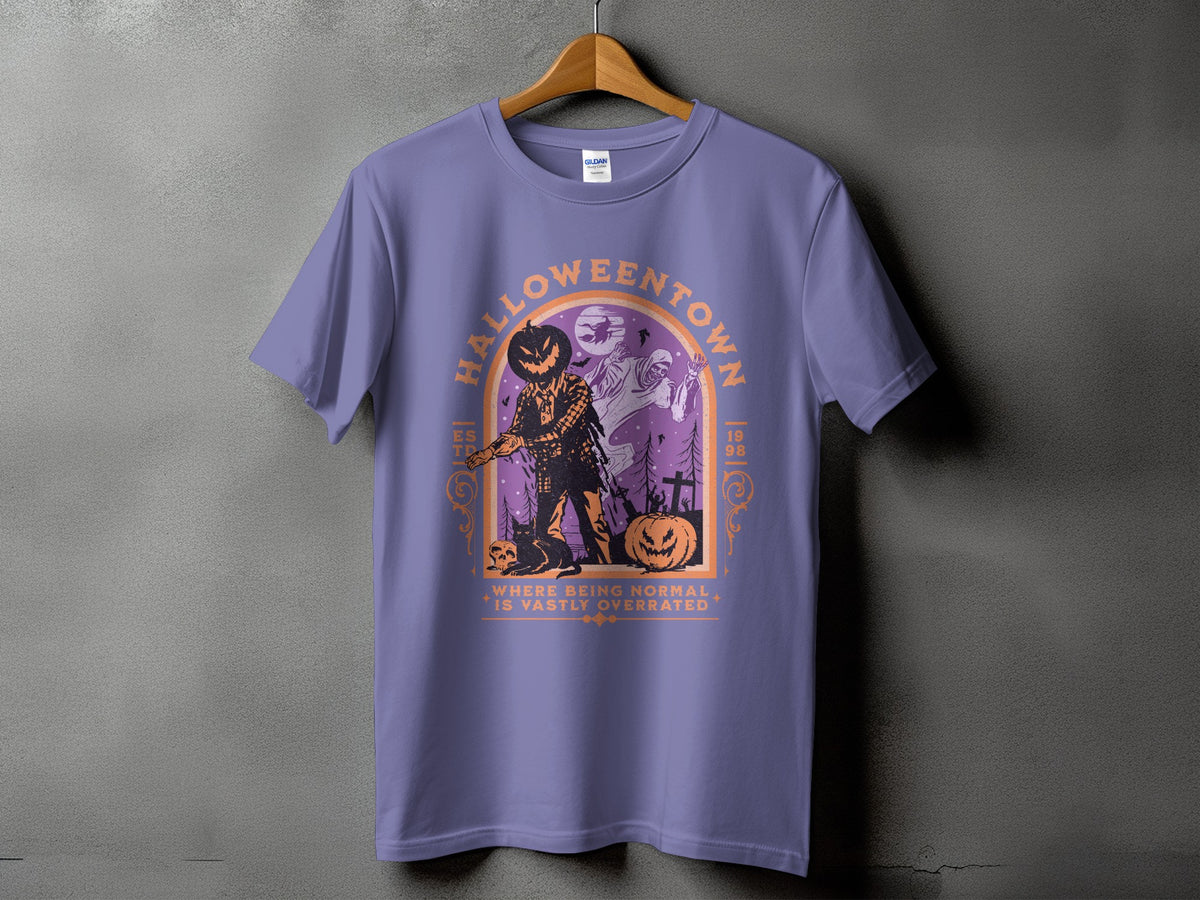 Purple t-shirt with a Halloween graphic featuring a scarecrow, ghost, and pumpkins.